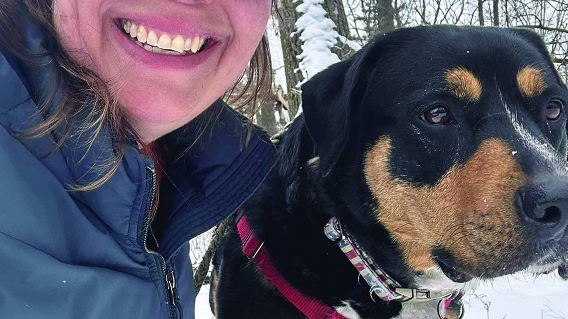 November 2025 cover artist Jennifer Zelinske with her dog Betsy Ross