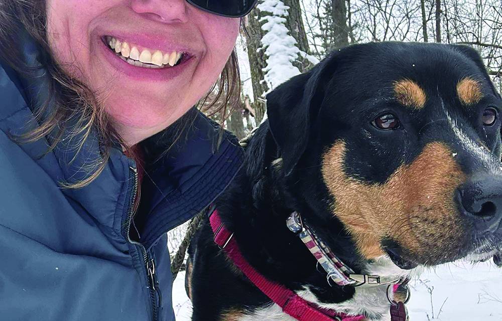 November 2025 cover artist Jennifer Zelinske with her dog Betsy Ross